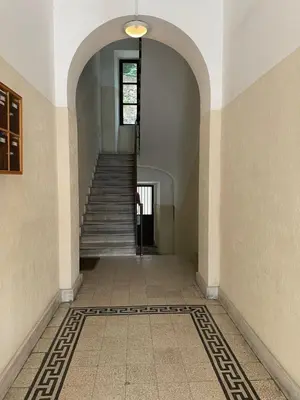 an empty hallway with stairs and a window at TrastevereLoft228 Apt. WHITE in Rome
