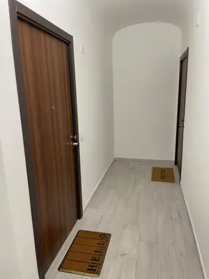 an empty room with a door and a wooden floor at TrastevereLoft228 Apt. WHITE in Rome