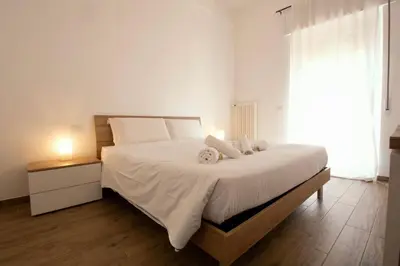 a bedroom with a large white bed with a window at Salotti 15 in Rome