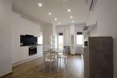 a kitchen with a table and chairs in a room at Salotti 15 in Rome