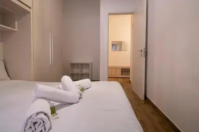 a bedroom with two beds with white sheets and towels at Salotti 15 in Rome