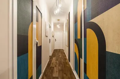 a hallway with colorful paintings on the walls at AlbaDea Déco&Jacuzzi in Rome
