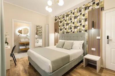 a bedroom with a large bed and a mirror at AlbaDea Déco&Jacuzzi in Rome