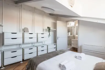 a bedroom with white cabinets and a bed at The Best Rent - Apartment near Castel Sant'Angelo in Rome