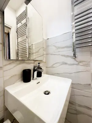 a bathroom with a white sink and a mirror at ZEUS GROUP VATICAN in Rome