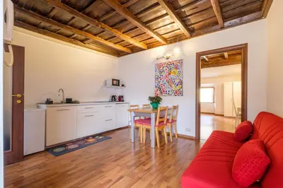 a living room with a red couch and a table at ht bilo colosseo in Rome