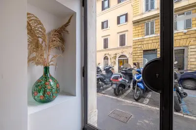 a vase sitting on a window sill next to motorcycles at HT BILO 2 COLOSSEO in Rome