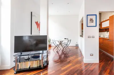 a living room with a large flat screen tv at La corte di Merlino - Apt centrale di pregio in Rome