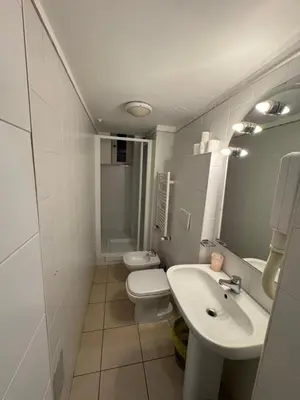 a bathroom with a sink and a toilet and a mirror at TERMINI STAR in Rome