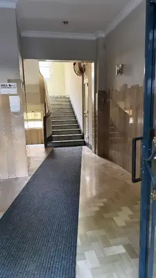a hallway with stairs in a building with a carpet at San Paolo Casa Bella in Rome
