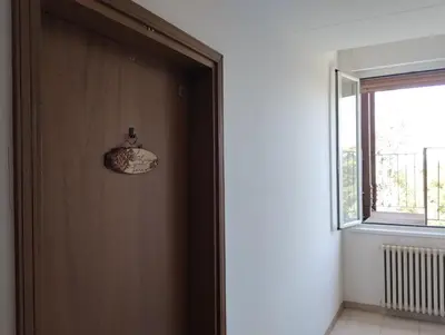 a wooden door in a room with a window at La Casa nel Parco - Stadio Olimpico, Auditorium con posto auto in Rome