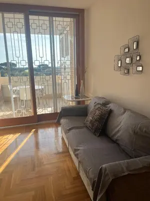 a living room with a couch in front of a glass door at Mi Casa Es Tu Casa Roma in Rome