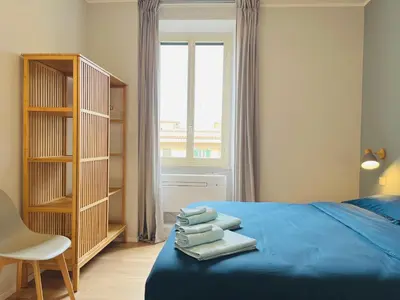 a bedroom with a blue bed with towels on it at Casa Duci in Rome