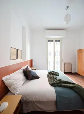a bedroom with a bed with a blanket on it at Nuovo appartamento a S. Lorenzo con 3 camere in Rome