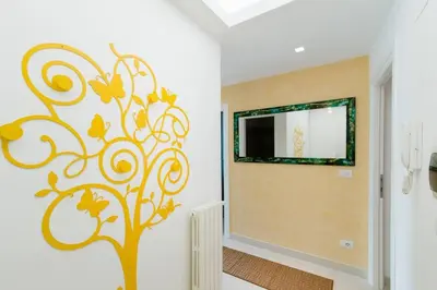 a room with a tree stenciled on the wall at Brightful Boutique Apartment in the Heart of Trastevere in Rome