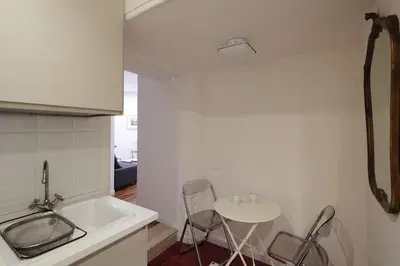 a kitchen with a sink and a table with chairs at Modern pied a terre near Piazza Navona in Rome