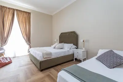 a bedroom with two beds and a window at Daplace - Livia Apartment in Rome