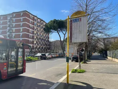 a bus stopped at a bus stop on a street at San Paolo Inn in Rome