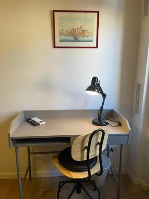 a desk with a lamp and a chair at San Paolo Inn in Rome