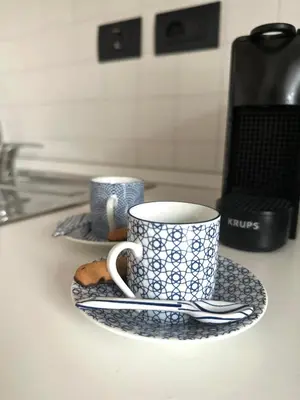 two cups and saucers on a kitchen counter at Hygge Studio in Rome