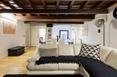 a living room with a couch and a dining room at iFlat Marvellous home near Via del Corso in Rome