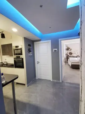 a room with a blue ceiling and a kitchen with a door at Dulcis in Fundo in Rome