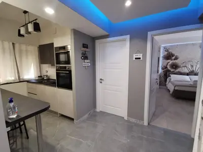 a kitchen with a white door and a blue ceiling at Dulcis in Fundo in Rome