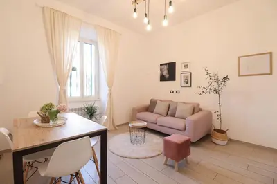 a living room with a couch and a table at San Pietro - moderno appartamento in Rome