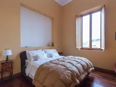 a bedroom with a large bed and a window at Apartment Le Colonne by Interhome in Rome