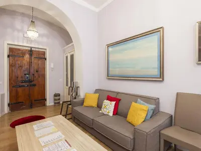 a living room with a couch and a table at Apartment Porta Magica by Interhome in Rome