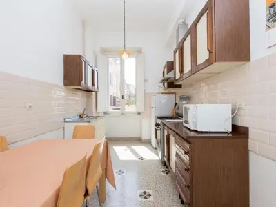 a kitchen with a table and chairs in a room at Apartment Angelico by Interhome in Rome