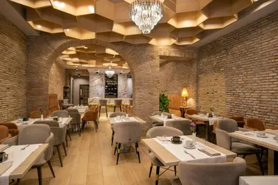 a restaurant with tables and chairs and a chandelier at Condotti Belvedere in Rome