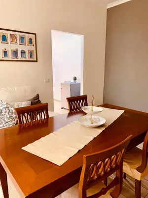a dining room with a wooden table and chairs at Family in Rome in Rome
