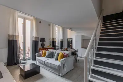 a living room with a couch and a staircase at iFlat Historic flat in campo de fiori in Rome