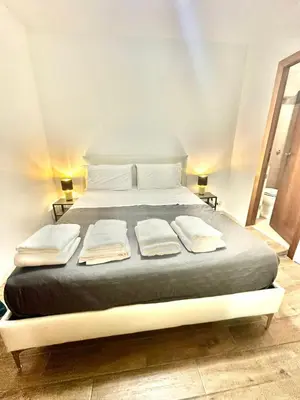 a large bed with two pillows on top of it at 150 meters from the Colosseum - Appartmento Gladiatore in Rome
