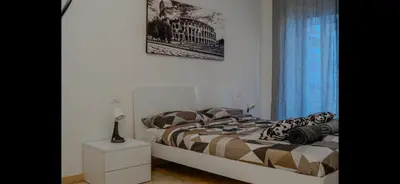 a bedroom with a bed and a window with a picture at Monti Deluxe Apartment in Rome