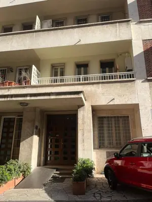 a red car parked in front of a building at Monti Deluxe Apartment in Rome