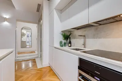 a white kitchen with a sink and a counter at BDC - The Platinum 2-Bdr apt @Spanish Steps in Rome