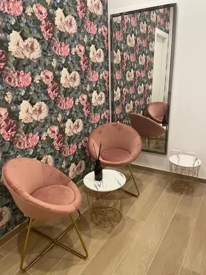 a room with two chairs and a wall with flowers at Domus Iulius in Rome
