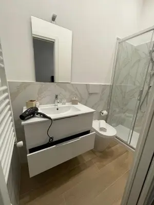 a bathroom with a sink and a toilet and a mirror at Domus Iulius in Rome