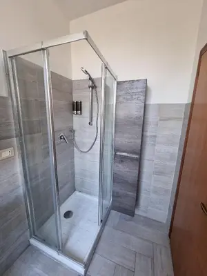 a shower with a glass enclosure in a bathroom at Loftiense Roma in Rome