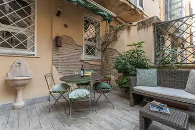 a patio with a table and chairs and a couch at PgrHome Boschetto in Rome