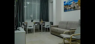 a living room with a couch and a table and chairs at Monti Exclusive Apartment in Rome