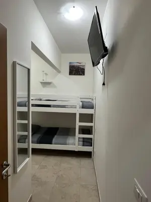 a room with a tv on a wall at Monti Exclusive Apartment in Rome