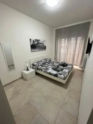 a bedroom with a bed and a window at Monti Royal Apartment in Rome