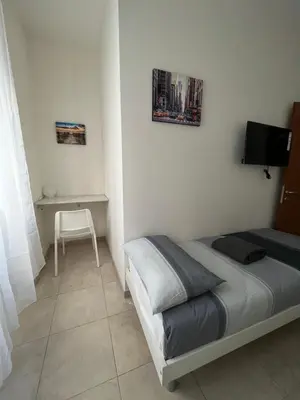 a small bedroom with a bed and a desk at Monti Royal Apartment in Rome