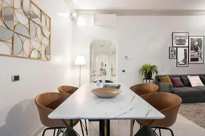 a living room with a white table and chairs at Angelique Boutique in Rome