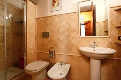a bathroom with a sink and a toilet and a shower at Casa Vacanza Colosseo in Rome