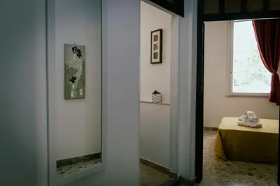 a mirror in a room with a bed and a window at GuestHouse Aurora ML in Rome