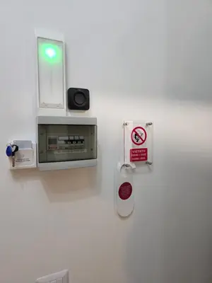 a white wall with a safe and a sign on it at GuestHouse Aurora ML in Rome